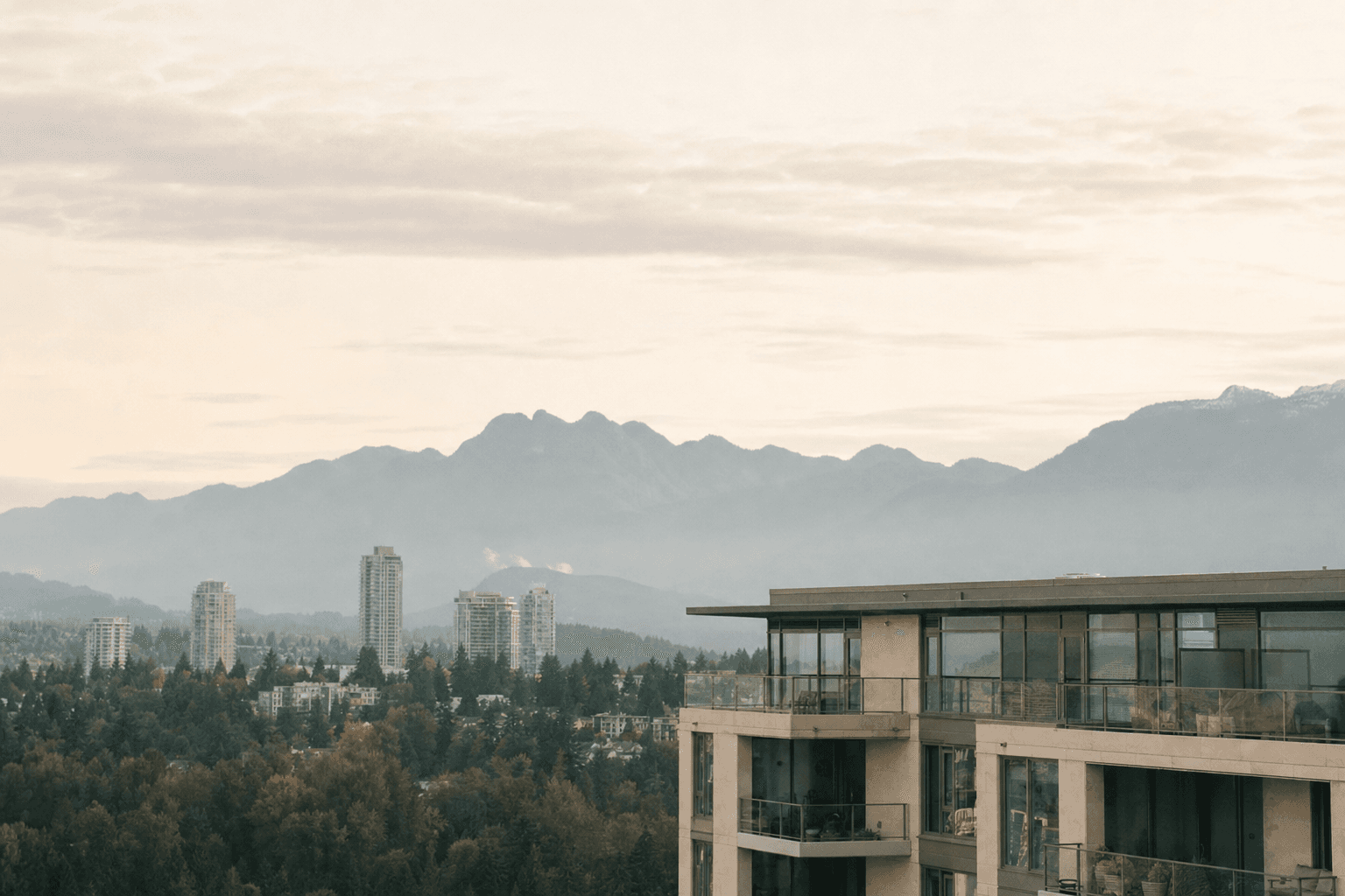 Wide Burnaby cityscape with North Shore mountains in the distance.